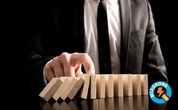 Businessman Stopping the Domino Effect